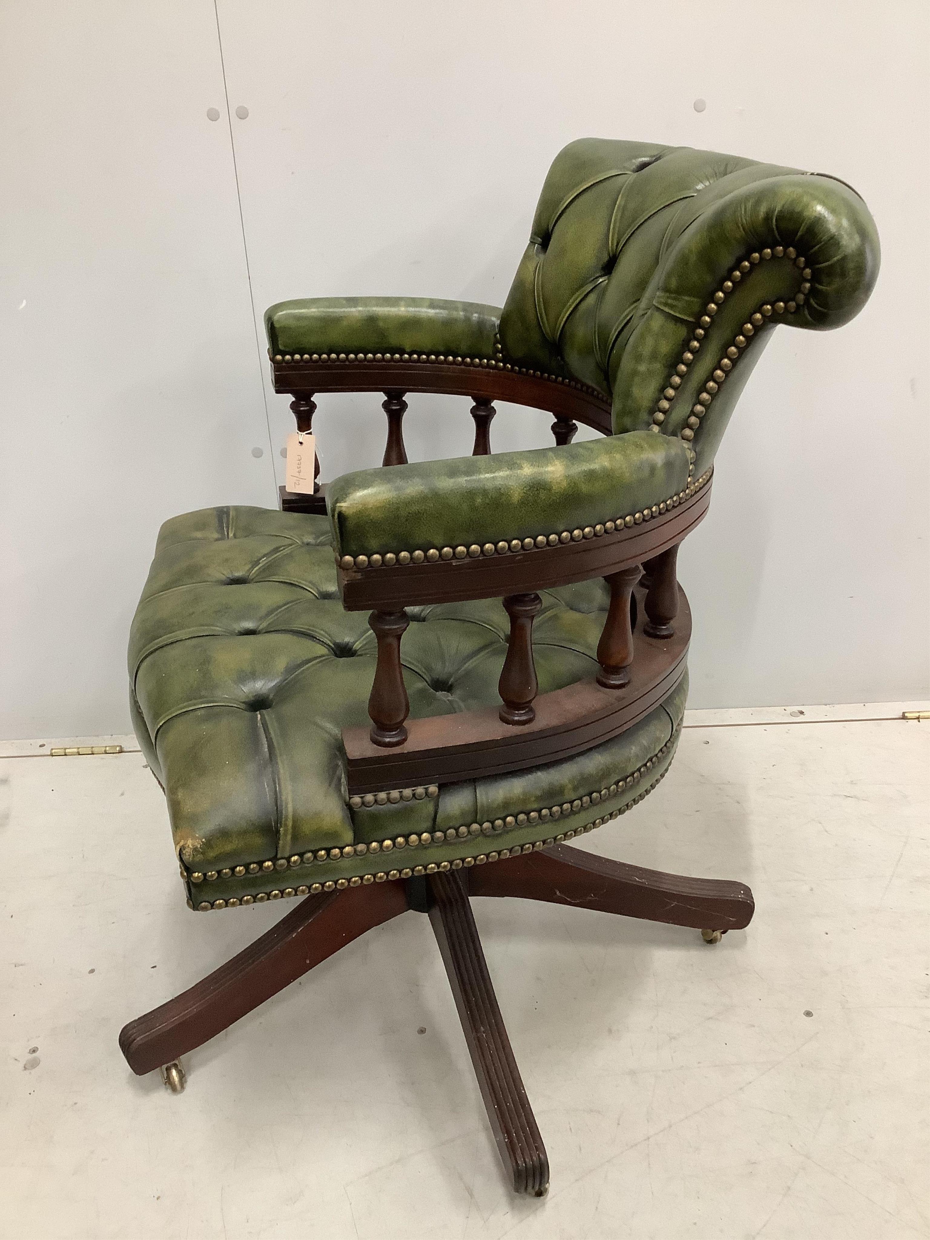 A reproduction Victorian style buttoned green leather swivel desk chair, width 63cm, depth 56cm, height 88cm